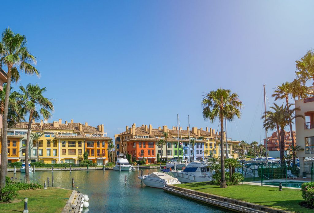 Waterfront homes and palm trees in Sotogrande Marina