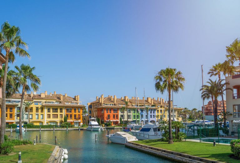 Waterfront homes and palm trees in Sotogrande Marina