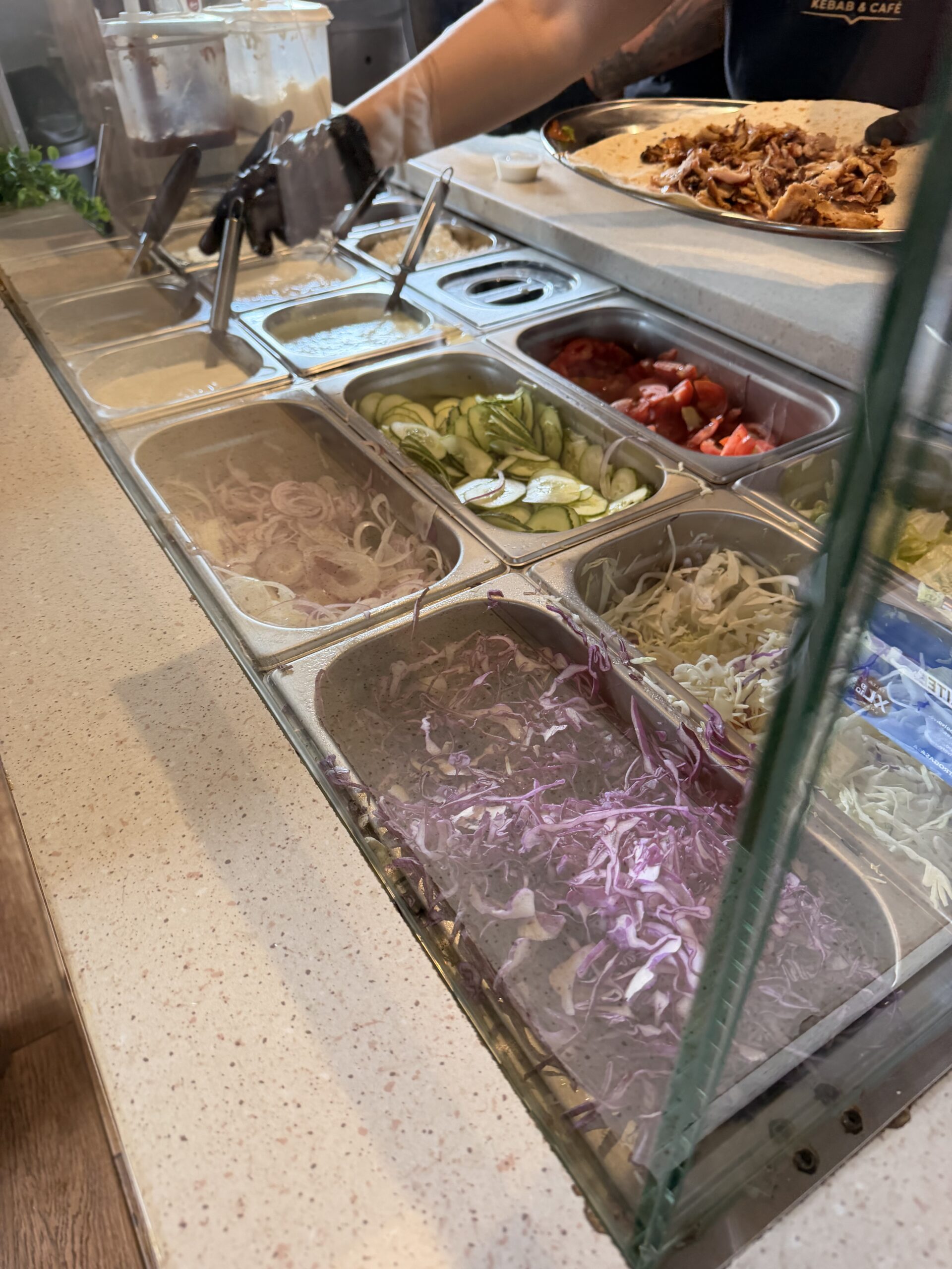 Salad ingredients and sauces at the Que?bab counter