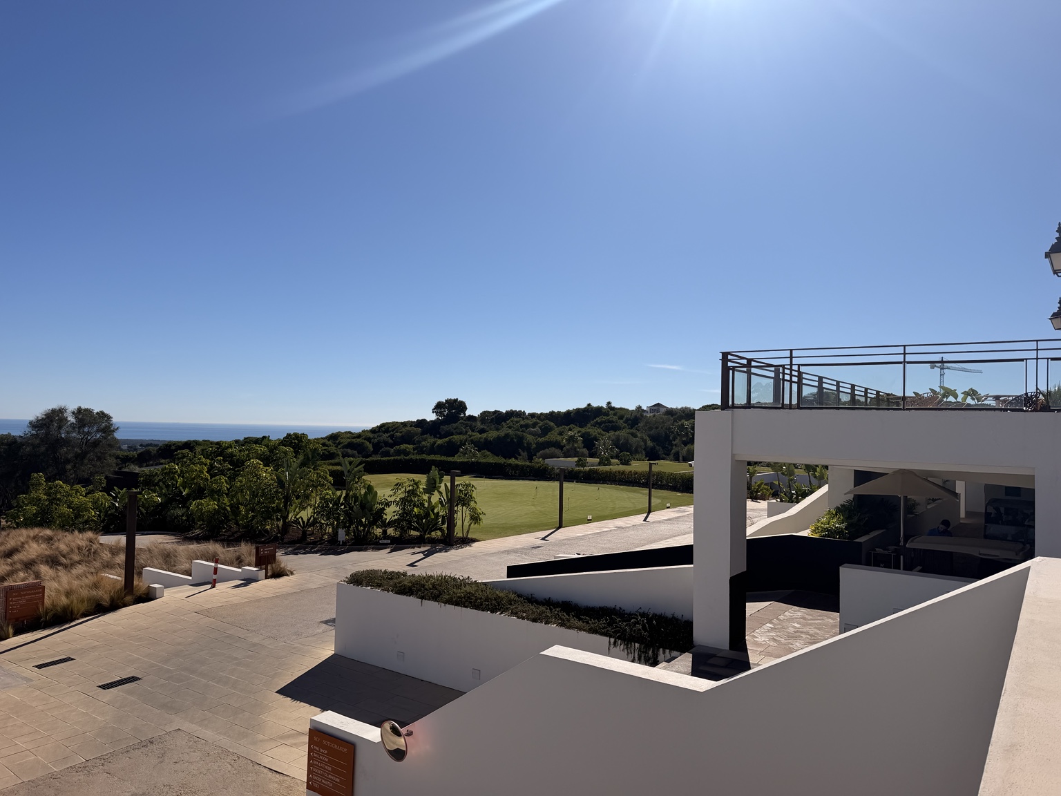 Terraces at SO/ Sotogrande overlooking a golf green, trees and the Mediterranean Sea